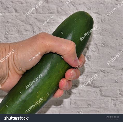 She pulls aside her panties, parts her. . Cucumber porn